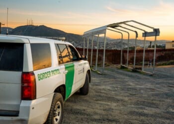 U.S. Border Patrol vehicle parked near the border wall in Tecate, California.