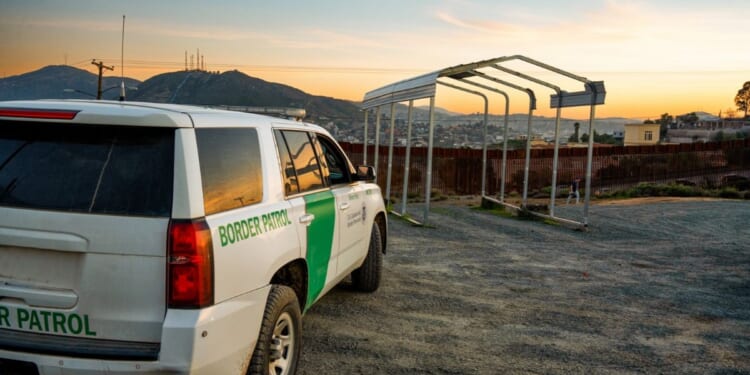 U.S. Border Patrol vehicle parked near the border wall in Tecate, California.