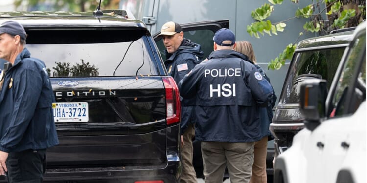 Homeland Security Investigations police search the Washington, D.C., home of Rep. Ilhan Omar, a Minnesota Democrat, Monday.