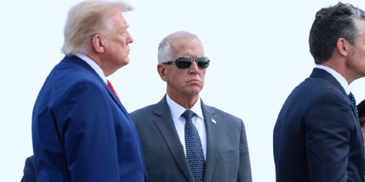 President Donald Trump and Sen. Thom Tillis are pictured in a July file photo from a ceremony marking the return of slain U.S. soldiers to American soil.