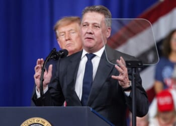 Audi AG CEO Gernot Dollner speaks alongside President Donald Trump during a midterm campaign rally at the Guardian Centers on Oct. 24, 2026, in Perry, Georgia.