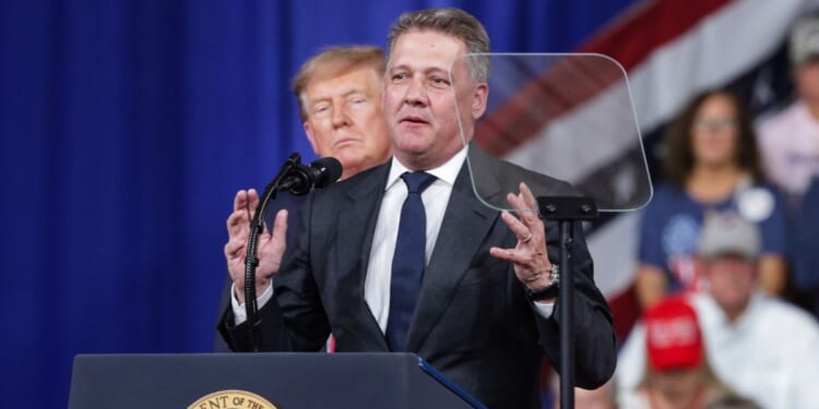 Audi AG CEO Gernot Dollner speaks alongside President Donald Trump during a midterm campaign rally at the Guardian Centers on Oct. 24, 2026, in Perry, Georgia.