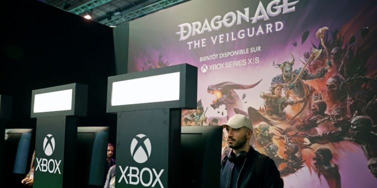 A gamer plays a video game developed by BioWare and published by Electronic Arts on the Xbox console during the "Paris Games Week" on Oct. 22, 2024, in Paris, France.
