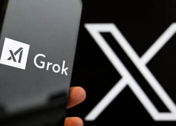 This photograph shows a smartphone bearing the logo of Grok, a generative artificial intelligence chatbot developed by xAI in front of the X logo in Brussels on Jan. 12, 2026.