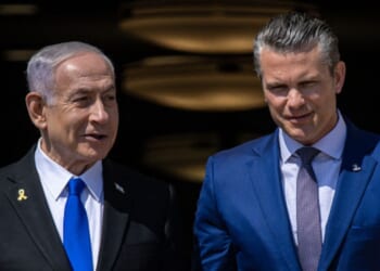 Prime Minister of Israel Benjamin Netanyahu and Secretary of War Peter Hegseth walk down stairs together on July 9, 2025 at the Pentagon.