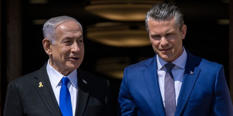 Prime Minister of Israel Benjamin Netanyahu and Secretary of War Peter Hegseth walk down stairs together on July 9, 2025 at the Pentagon.