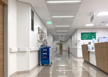 An empty hospital hallway is pictured.