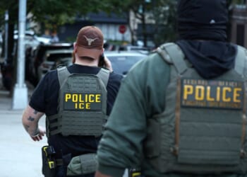 Federal agents walk near the scene where a man was shot by an Immigration and Customs Enforcement officer during an operation in the Bronx borough of New York on Oct. 8, 2026, according to local media and police.