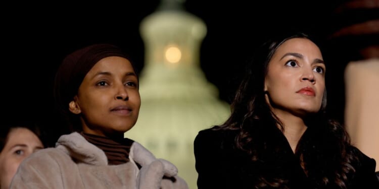 Rep. Ilhan Omar and Rep. Alexandria Ocasio-Cortez listen during a news conference calling for a ceasefire in Gaza outside the U.S. Capitol building on Nov. 13, 2023, in Washington, D.C.