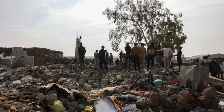 People inspect the damage Tuesday at a site targeted by airstrikes, carried out the night before by Jordan on the village of Al-Taf in the Al-Lajat region, located in the northeastern countryside of Daraa. Jordan said it had killed more than 20 Islamic State group jihadists in strikes on Syria in retaliation for a deadly attack on a church.