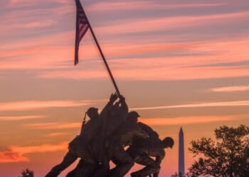 Sunrise turns the sky orange and red behind the U.S. Marine Corps War Memorial on Oct. 2, 2026, in Arlington, Virginia.
