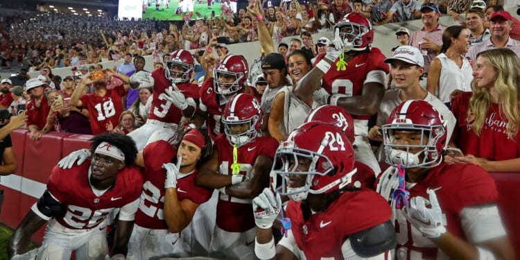 Alabama Crimson Tide players pose with fans after beating the Florida State Seminoles 50-36 at Bryant-Denny Stadium on Sept. 19, 2026 in Tuscaloosa, Alabama. Alabama is scheduled to host the Georgia Bulldogs Saturday at 7:30 p.m. in Tuscaloosa.
