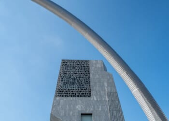 A stainless steel arch sculpture, Bending the Arc by artist Martin Puryear, frames the main tower of the Obama Presidential Center in Chicago's historic Jackson Park.