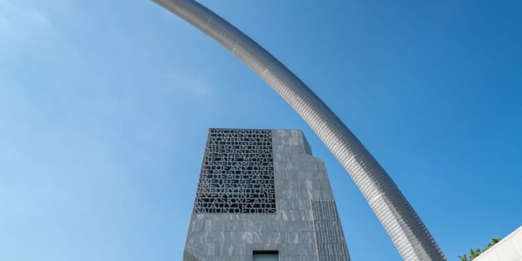 A stainless steel arch sculpture, Bending the Arc by artist Martin Puryear, frames the main tower of the Obama Presidential Center in Chicago's historic Jackson Park.