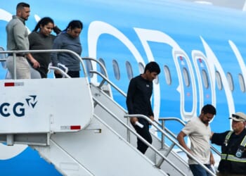 Migrants deported from the United States get off an airliner at the runway of the Juan Santamaria International Airport in Alajuela, Costa Rica, on April 11.