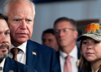 Vice Presidential candidate and Minnesota Governor Tim Walz stands with his daughter Hope Walz and DemocraticCongressman Ruben Gallego of Arizona in Phoenix, Arizona, on Aug. 9, 2024.