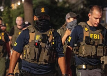 FBI agents walk down Florida Ave between 14th street NW and 13th street NW on Aug. 13, 2025, in Washington, D.C.
