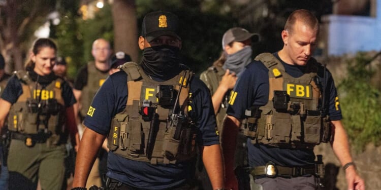 FBI agents walk down Florida Ave between 14th street NW and 13th street NW on Aug. 13, 2025, in Washington, D.C.
