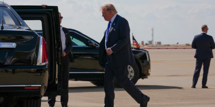 President Donald Trump walks to the presidential limousine nicknamed "The Beast" in a September file photo from the Dallas-Fort Worth Airport.