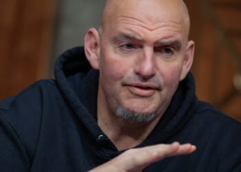 Sen. John Fetterman prepares to vote to advance Sen. Markwayne Mullin to be Secretary of the Department of Homeland Security during a markup hearing in the Dirksen Senate Office Building on Capitol Hill on March 19, 2026, in Washington, D.C.